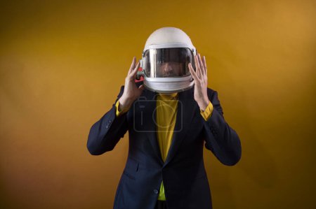 Photo for Businessman with astronaut helmet looking to the side - Royalty Free Image