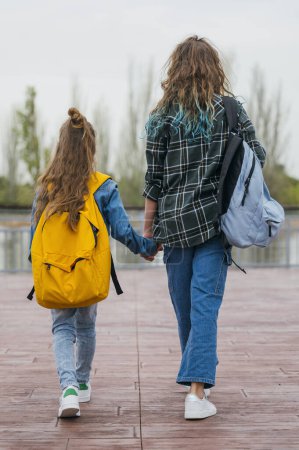 Photo for A teenage girl who goes to school with her little brother. - Royalty Free Image
