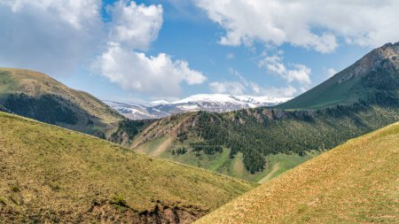 Photo for Kyrgyzstan nature green landscape with vast mountains. Kyrgyzstan is a landlocked country located in central Asia, known for its rugged, mountainous terrain and verdant grasslands. - Royalty Free Image