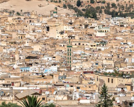 Photo for Fes city skyline with green tiled minaret of the Mosque Sidi Ahmed Tijani is a reminder of the city's rich history and heritage, Morocco - Royalty Free Image