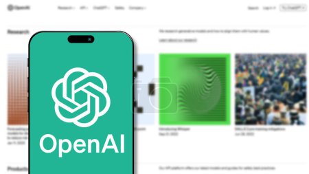 Photo for Istanbul, Turkey - 19 Feb 2024: OpenAI logo on smartphone screen with its website in background. OpenAI is a leading AI research and development organization, famous for ChatGPT - Royalty Free Image