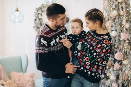 Photo for Portrait of happy family of father mother and little curly son celebrating Christmas together at home. New Year`s Eve concept. - Royalty Free Image