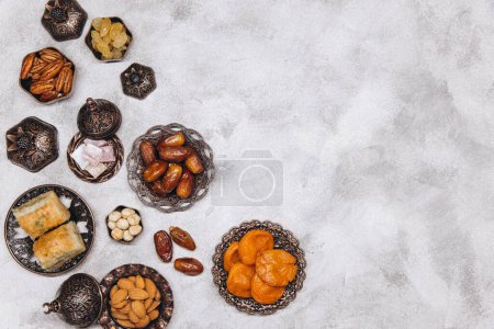 Photo for Ramadan kareem Iftar party table with assorted festive traditional Arab dishes, sweets, dates. Eid al-Fitr mubarak evening grand meal, top view. - Royalty Free Image