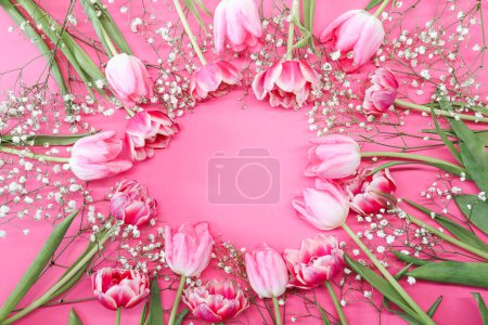 Foto de Tulipanes rosados y un ramo blanco de flores de gypsophila alrededor de un fondo rosa. Día de la madre, concepto de celebración de cumpleaños. Copia espacio para texto. Burla. - Imagen libre de derechos