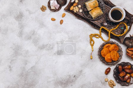 Photo for Banner with traditional Arabic dishes and food sets on it, Koran and rosary. Ramadan table top view - Royalty Free Image