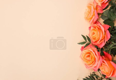 Téléchargez les photos : Bouquet de roses orange sur fond beige. Fête des mères, Saint Valentin, concept de célébration d'anniversaire. Carte de vœux. Espace de copie pour le texte, vue du dessus - en image libre de droit