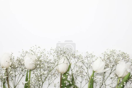 Téléchargez les photos : Bouquet de fleurs de tulipes blanches et gypsophiles sur fond blanc. Fête des Mères, concept de fête d'anniversaire. Espace de copie pour le texte - en image libre de droit