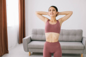 Attractive and healthy young woman doing exercises while resting at home Tank Top #646359994