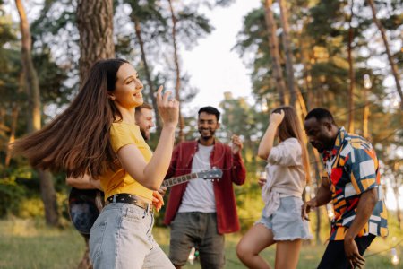 Photo for Multiracial group of people, beautiful hipster woman dancing on the background of friends having fun - Royalty Free Image