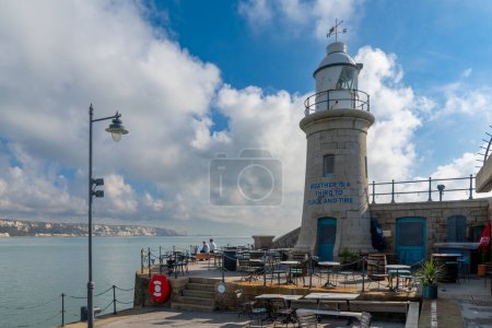 Photo for Folkestone, United Kingdom - 11 September, 2022: the Folkestone Harbor arm with the historic lighthouse - Royalty Free Image