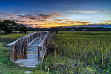 long wooden dock on the inlet at Pawleys Island in South Carolina at usnset