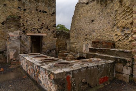 Photo for Ercolano, Italy - 25 November, 2023: Roman toilets in the ancient city of Herculaneum near Napoli - Royalty Free Image