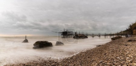Photo for Trabocco Punto Le Morge on a rainy day under a cloudy sky long exposure on the Abruzzo Coast - Royalty Free Image