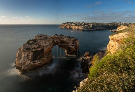 A long exposure view of the natural limestone arch of Es Pontas on Mallorca