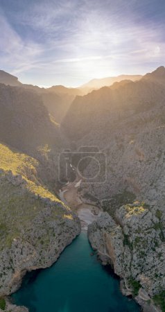 A vertical view of the Torrent de Pareis Gorge and beach on the rugged mountain coast of northern Mallorca