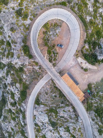 Top-down aerial view of the Nus de Sa Corbata hairpin turn in the Serra Tramuntan of Mallorca near Coll de Reis mountain pass