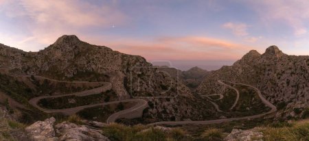 panorama sunrise landscape in the Tramuntana mountains of Mallorca with a view of the landmark snake road leading down to Sa Calobra