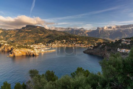A view of the natural bay and harbour of Port de Soller in northern Mallorca in warm evening light
