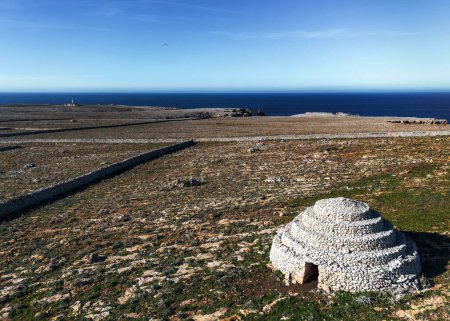 A view of the typical stone walls and fields encasing the historic Talayot stone houses on Menorca Island in Spain