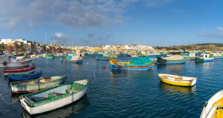 Photo for Marsaxlokk, Malta - 22 December, 2023: colorful fishing boats in the harbor of Marsaxlokk in southeastern Malta - Royalty Free Image