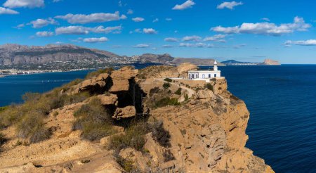 Photo for A view of the Albir Lighthouse on the rocky promontory in the Serra Gelada Natural Park between Benidorm and Altea - Royalty Free Image