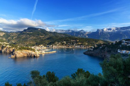 A view of the natural bay and harbour of Port de Soller in northern Mallorca in warm evening light