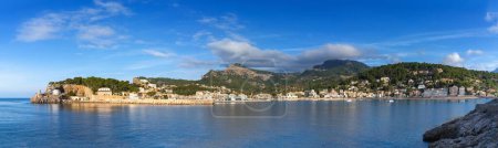 A panorama view of the natural bay and harbour of Port de Soller in northern Mallorca in warm evening light