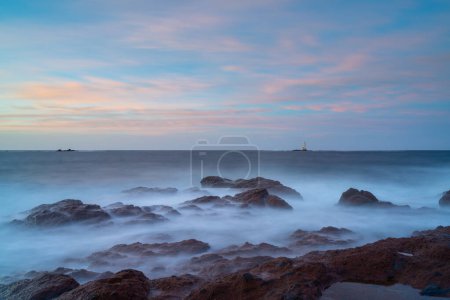 Long view of the Mangiabarche Lighthouse at sunrise on Sardinia
