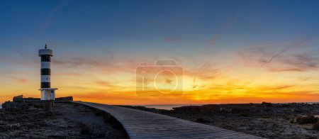 A panorama view of the lighthouse at Colonia Sant Jordi in Mallorca at sunset