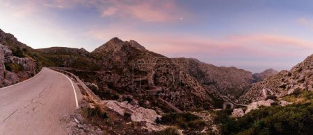 panorama sunrise landscape in the Tramuntana mountains of Mallorca with a view of the landmark snake road leading down to Sa Calobra