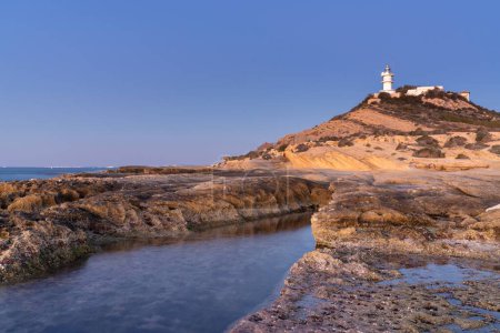 A view of the Cabo de la Huerta lighthouse at sunrise