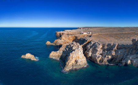 drone view of the Punta Nati lighthouse and coastal cliffs in northwestern Menorca