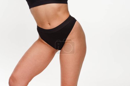 Photo for A woman with a beautiful feminine figure in black lingerie with overweight, cellulite and stretch marks. Obesity, hormones and health. Isolated ona white background. - Royalty Free Image