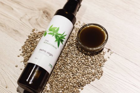 Photo for Hemp raw oil with hemp seed on background, close up - Royalty Free Image