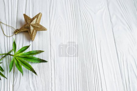 Foto de Hoja de cannabis sobre blanco. Planta de cáñamo en una canasta sobre una mesa de madera blanca. 2023. El año que viene con cannabis medicinal - Imagen libre de derechos