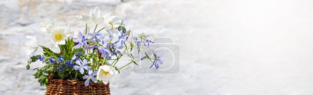 Photo for Flowers Bouquet Anemonoides nemorosa, Phlox divaricata, Whetzel weed in Wisker Basket. - Royalty Free Image