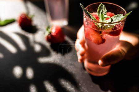 Photo for Strawberry lemonade punch. A delightful mix of tangy lemonade and luscious strawberries, served in a glass with ice cubes. The vibrant red color and juicy strawberry slices. - Royalty Free Image