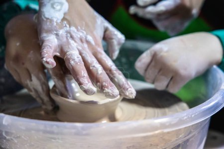 Photo for Hands-on instruction from a talented pottery teacher - Royalty Free Image