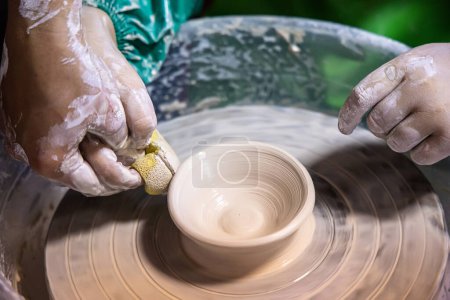 Photo for Budding potter embraces the challenges of shaping clay into a plate. - Royalty Free Image