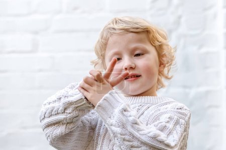 Photo for Sweet victory expressed with two little fingers playfully extended. - Royalty Free Image