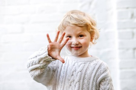 Photo for Counting with tiny hands, five little fingers make an appearance. - Royalty Free Image