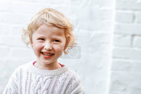 Photo for Pure and infectious joy radiates from the childs sweet smile. - Royalty Free Image