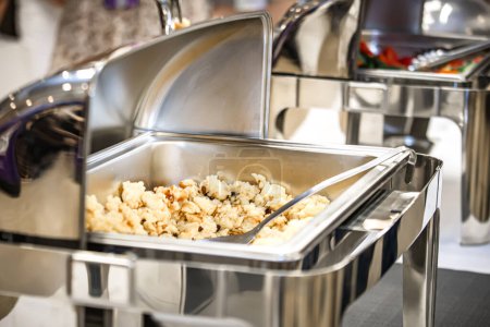 Photo for Catering buffet food indoor during a business lunch at the conference. Close up of a stainless steel catering buffet in a hotel restaurant. - Royalty Free Image