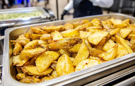 Photo for Fried potatoes in a stainless steel tray in a restaurant or cafe - Royalty Free Image