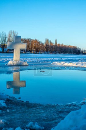 Photo for Holidays of Orthodox baptism. Ice cross hole and a cross of ice in Ukraine - Royalty Free Image