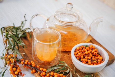 Photo for Aromatic sea buckthorn tea in a clear glass teapot, showcasing its vibrant color goodness of organic sea buckthorn tea, a healthy choice - Royalty Free Image