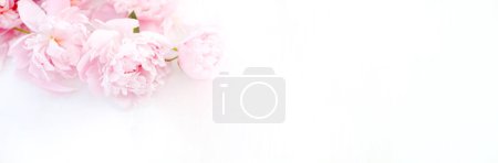 Photo for Delightful bouquet of blooming peonies in shades of pink, creating a romantic and festive atmosphere on white table. Top view. Empty space for your text. Wedding or Valentine day concept - Royalty Free Image