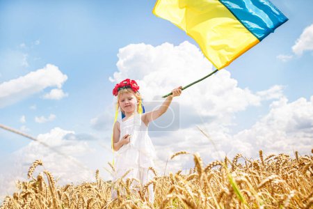 Photo for Child with the Ukrainian flag in hand - Royalty Free Image