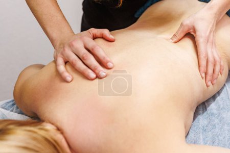 Luxuriate in a blissful back massage experience with a trained masseur in a serene spa ambiance. Beauty Treatment concept