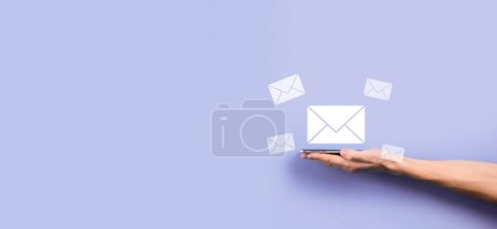 Photo for Businessman hand holding letter icon,email icons.Contact us by newsletter email and protect your personal information from spam mail.Customer service call center contact us.Email marketing newsletter - Royalty Free Image